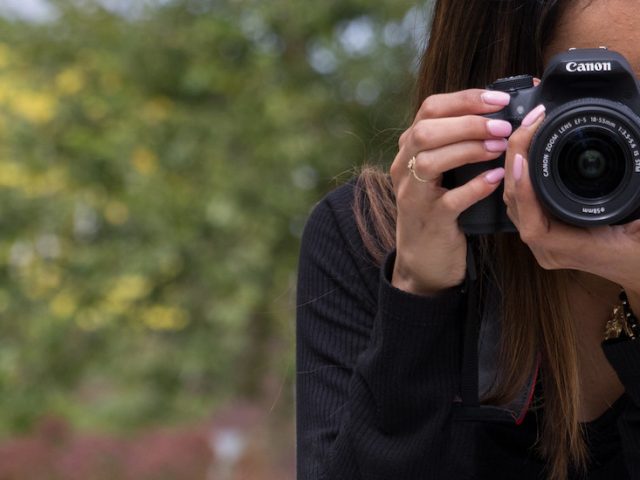 A Rowan student uses a DSLR camera to capture a moment.