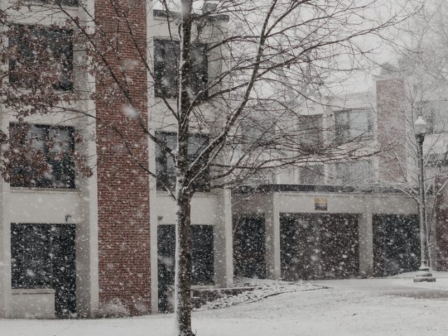 Exterior shot of falling snow outside a residence hall.