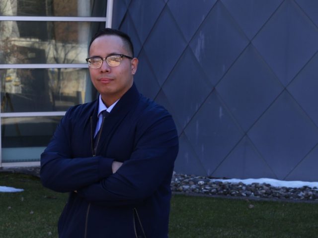 Abraham poses in front of Science Hall.