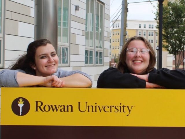 Two Rowan students stand in front of 301 High St.