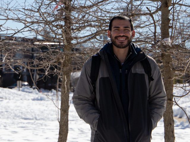 Jericho smiles, stands outside of Rowan Boulevard.