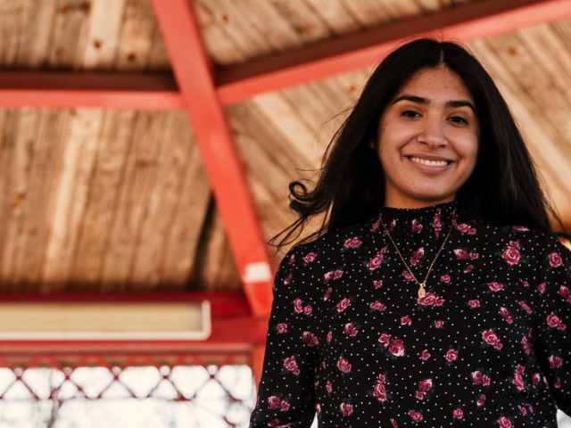 Brittany stands underneath a gazebo on campus.