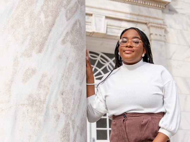 Arielle poses next to a pillar at Bunce Hall.