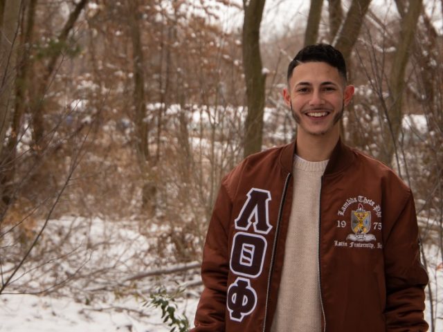 Chris Acevedo poses in a wooded, snowy area.