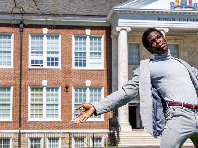 Joshua poses outside of Bunce Hall.