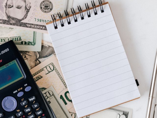 Stock image of a notepad and calculator.