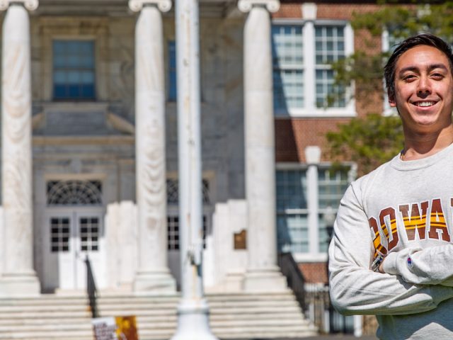 JT stands confidently in front of Bunce Hall.