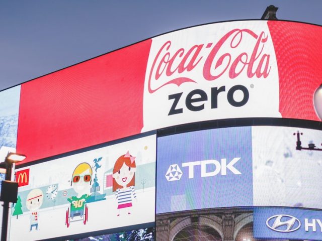 Stock image of brightly lit advertising on a wall.