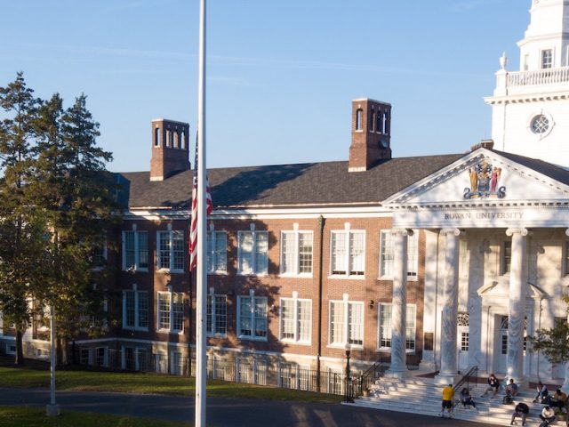 Photo taken by a drone of Bunce Hall with students sitting on the marble steps.