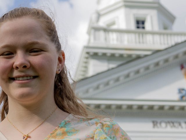 Bianca smiles with the top of Bunce Hall in the background.