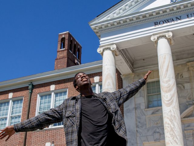 Femme in front of Bunce Hall