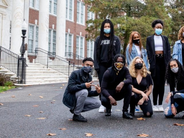 PROFFAMILY poses next to Bunce Hall.