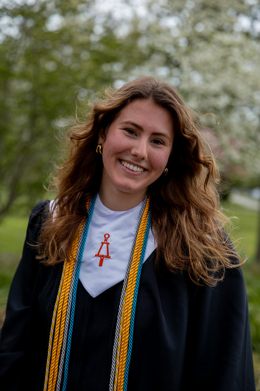 Alexa smiles in her graduation gown.