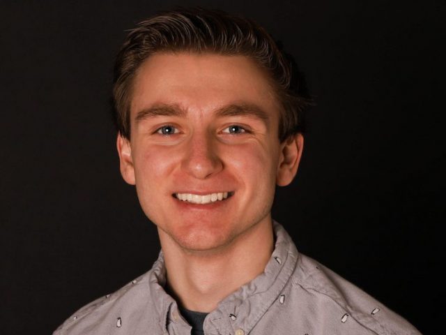 Headshot of Brian Seay against a black backdrop.