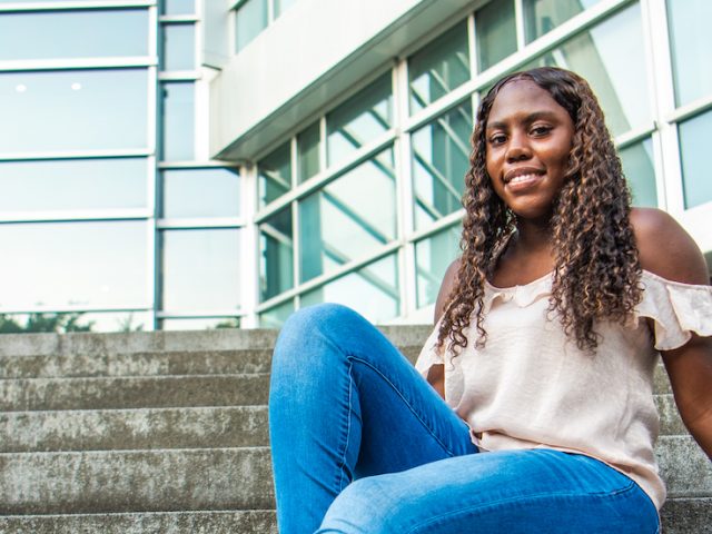 Keyanna sits on the steps by Engineering pond.