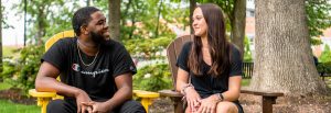 Natalie sits with her coworker Reshaun on campus.