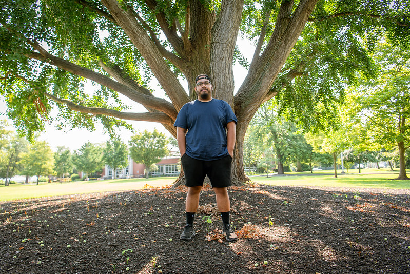 Alex stands in front of a tree on Bunce Green.