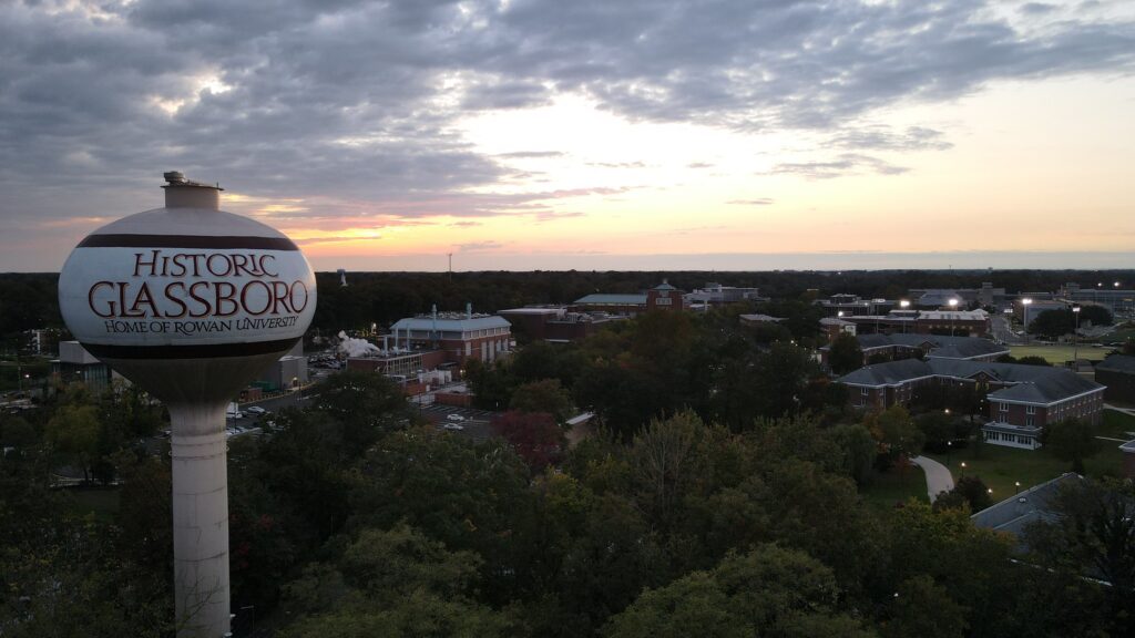 A drone photo from outside Holly Pointe Commons showing a skyline view of Glassboro with the Historic Glassboro water tower in the foreground.