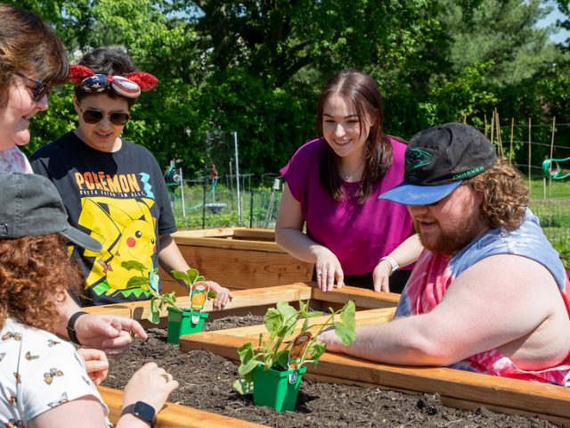 The Borgerson family and Jenna see the raised beds at the Williamstown Organic Community Garden.