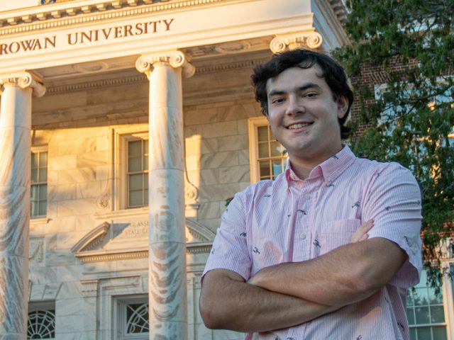 Nick smiles, stands in front of Bunce Hall.