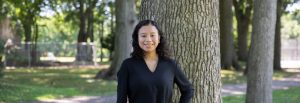Erika poses in front of a tree.