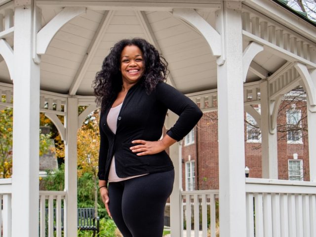 Psychology major Mel poses in a gazebo near Bunce Hall.