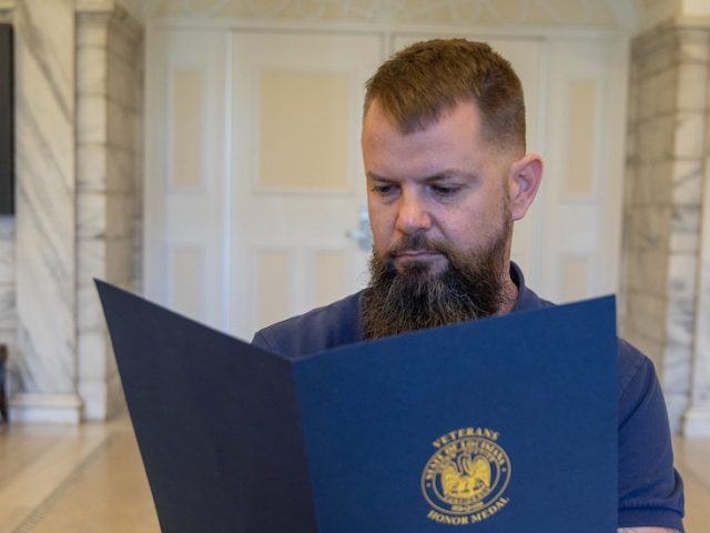 Morgan looks at an award inside Bunce Hall.