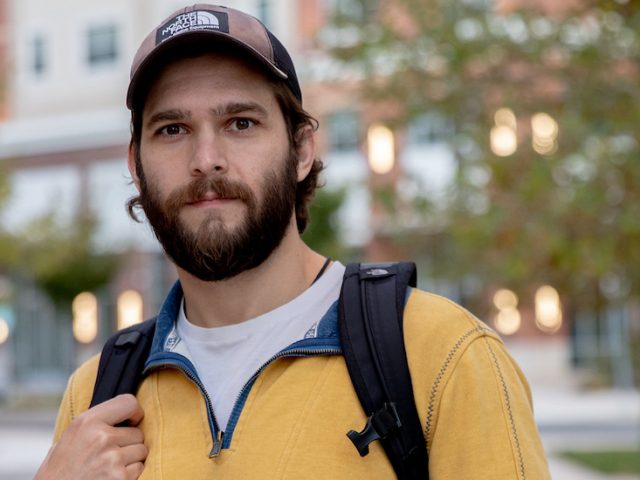 Alex stands on one of the pathways along Rowan Boulevard.