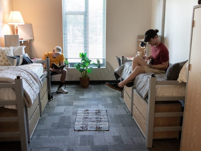 Two first year students hang out in their dorm.