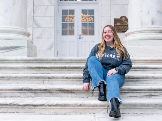 Paige sits on Bunce Hall steps.