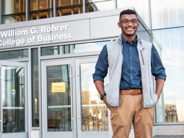 Bryan poses in front of Business Hall.