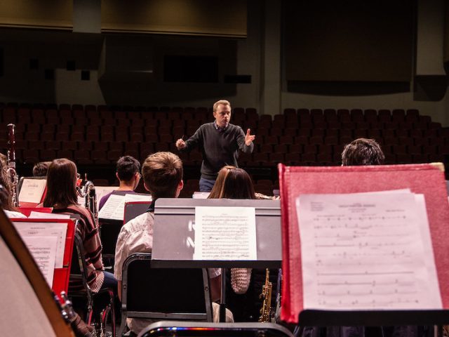 Dr. Joseph Higgins leads a practice performance in Pfleeger Hall.