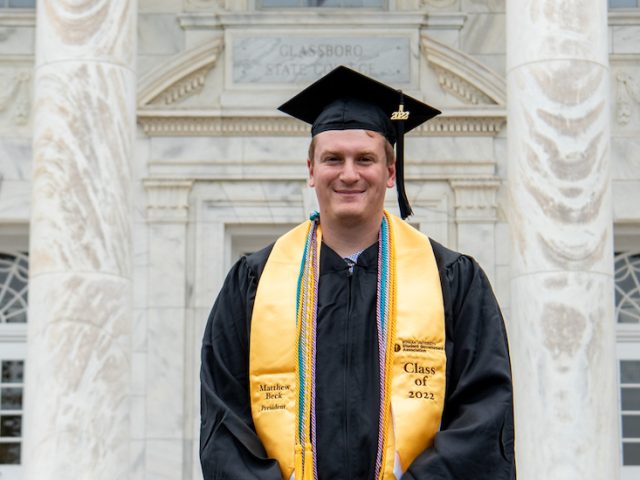 Matthew Beck stands in front of Bunce Hall.