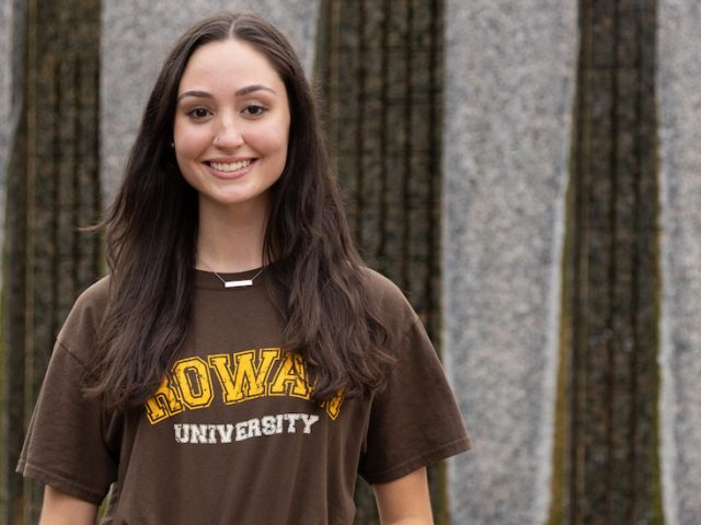 Zara poses outside on campus.