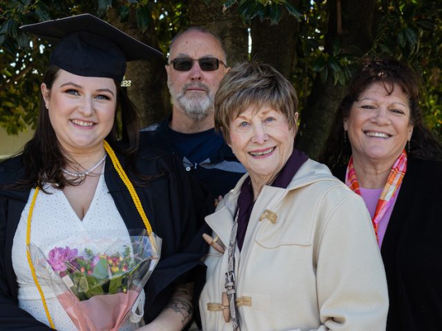 Carly with family at her graduation.