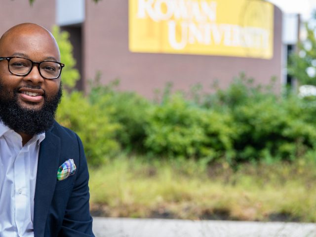 Music Education Assistant Professor Dr. Adrian Barnes sits outside Wilson Hall.