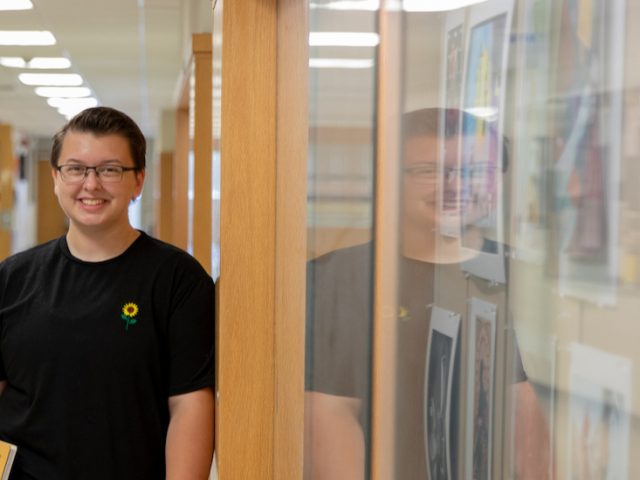 Emerson standing in Westby Hall.