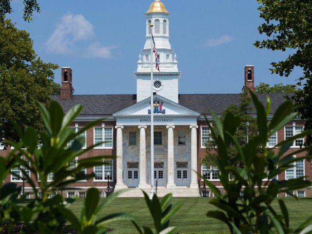 Bunce Hall on Rowan's Glassboro Campus behind some foliage.