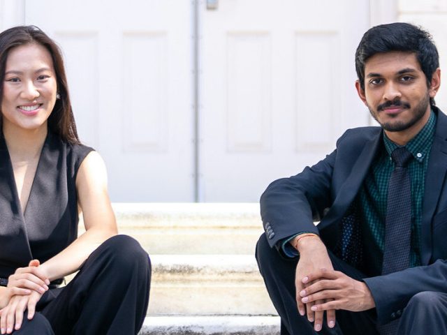 Naman and Terry are sitting on the stairs of Bunce Hall.