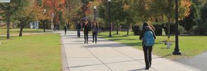 Rowan University students walk on campus on a fall day.