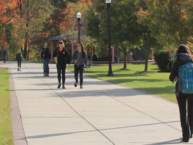 Rowan University students walk on campus on a fall day.