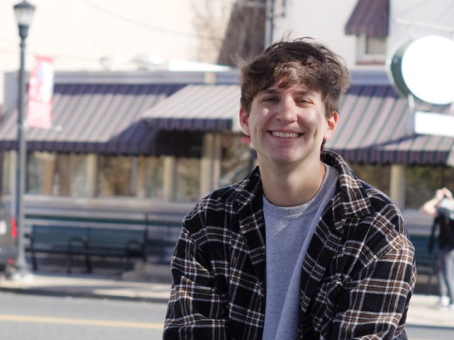 Jon smiles outside in on Glassboro Town Square.