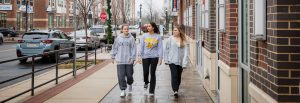 Biomedical Engineering major Miral walks down Rowan Boulevard with two friends.