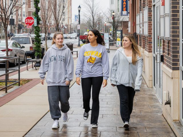 Biomedical Engineering major Miral walks down Rowan Boulevard with two friends.