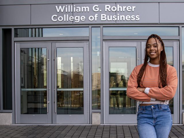 Lanasia stands outside the Rohrer College of Business building.