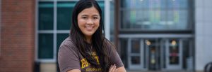 Rowan Leadership and Social Innovation major Tammy stands in front of James Hall.
