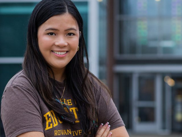 Rowan Leadership and Social Innovation major Tammy stands in front of James Hall.