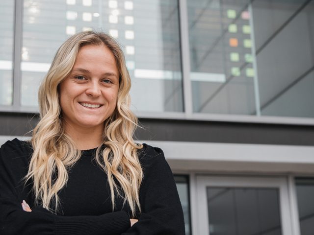 Kristiina Castagnola poses in front of James Hall.