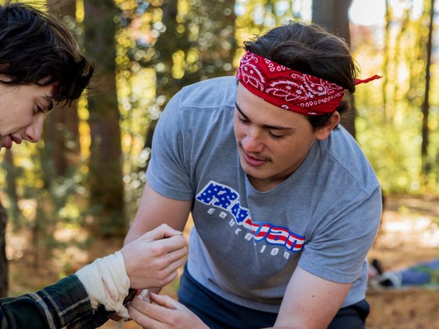 Rowan Health and Physical Education major Gabriel Sherry treats another student in a scenario in Rowan's Wilderness First Responder course.