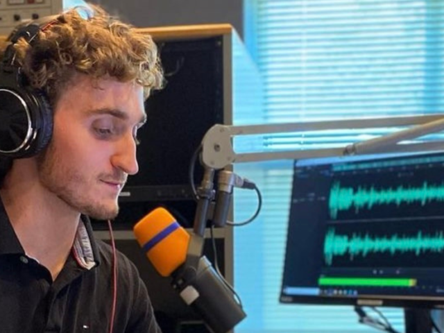 Danny Ryan sits working in front of a microphone at Rowan Radio.